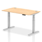 Adjustable height desk with wood-effect top and metal legs on a white background
