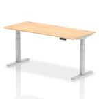 Adjustable height desk with wood-effect top and metal legs on a white background