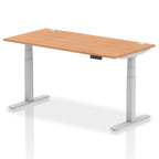 Adjustable height desk with wood-effect top and metal legs on a white background