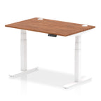 Adjustable height desk with wood-effect top and metal legs on a white background