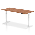 Adjustable height desk with wood-effect top and metal legs on a white background