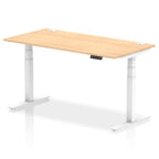 Adjustable height desk with wood-effect top and metal legs on a white background
