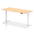 Adjustable height desk with wood-effect top and metal legs on a white background