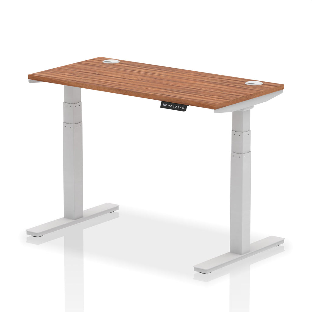 Adjustable height desk with wood-effect top and metal legs on a white background