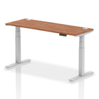 Adjustable height desk with wood-effect top and metal legs on a white background