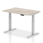 Adjustable height desk with wood-effect top and metal legs on a white background