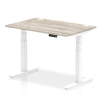 Adjustable height desk with wood-effect top and metal legs on a white background