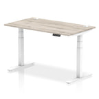 Adjustable height desk with wood-effect top and metal legs on a white background