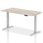 Adjustable height desk with wood-effect top and metal legs on a white background