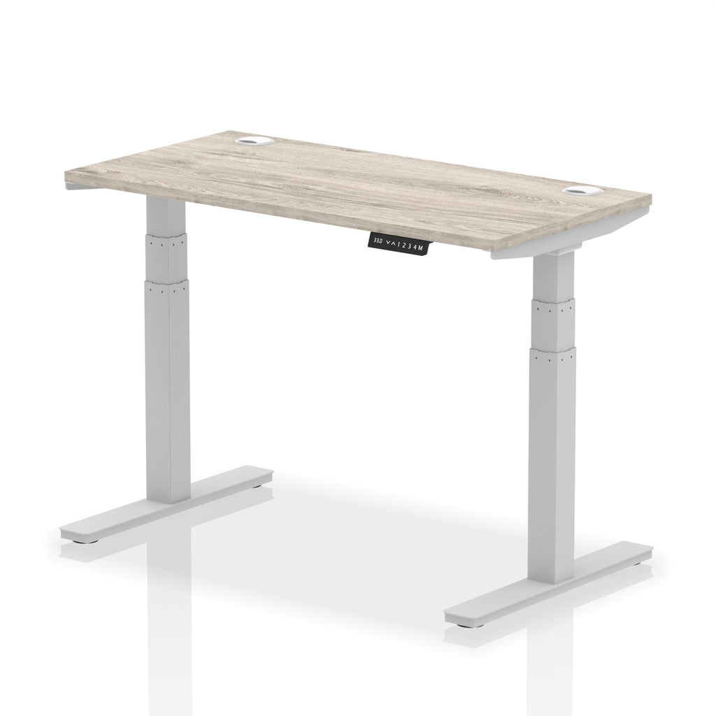 Adjustable height desk with wood-effect top and metal legs on a white background