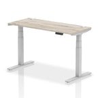 Adjustable height desk with wood-effect top and metal legs on a white background