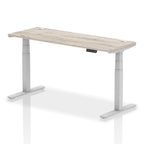 Adjustable height desk with wood-effect top and metal legs on a white background
