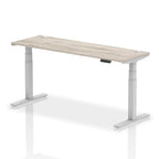 Adjustable height desk with wood-effect top and metal legs on a white background
