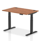 Adjustable height desk with wood-effect top and metal legs on a white background