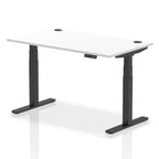 Adjustable height desk with white top and metal legs on a white background