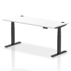 Adjustable height desk with white top and metal legs on a white background