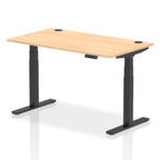 Adjustable height desk with wood-effect top and metal legs on a white background