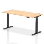 Adjustable height desk with wood-effect top and metal legs on a white background