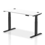 Adjustable height desk with white top and metal legs on a white background