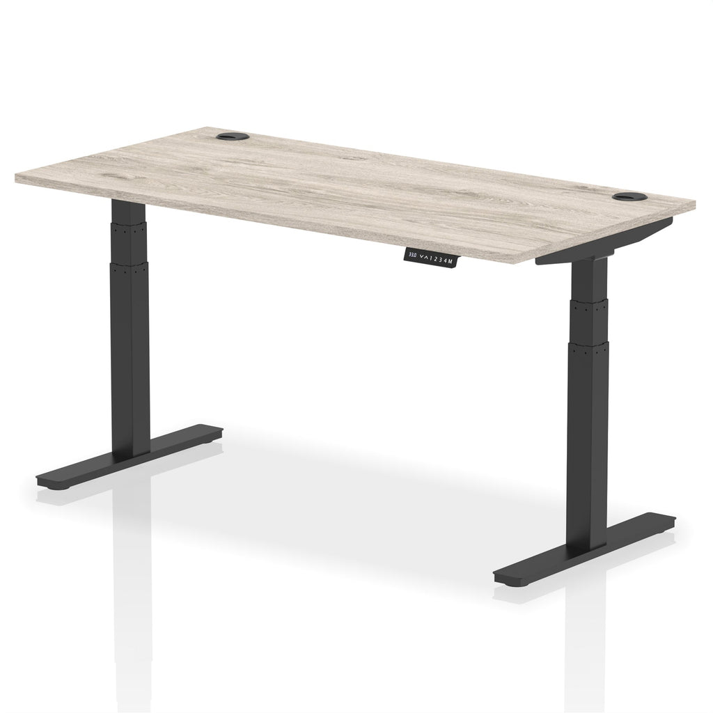 Adjustable height desk with wood-effect top and metal legs on a white background