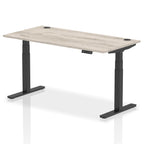 Adjustable height desk with wood-effect top and metal legs on a white background