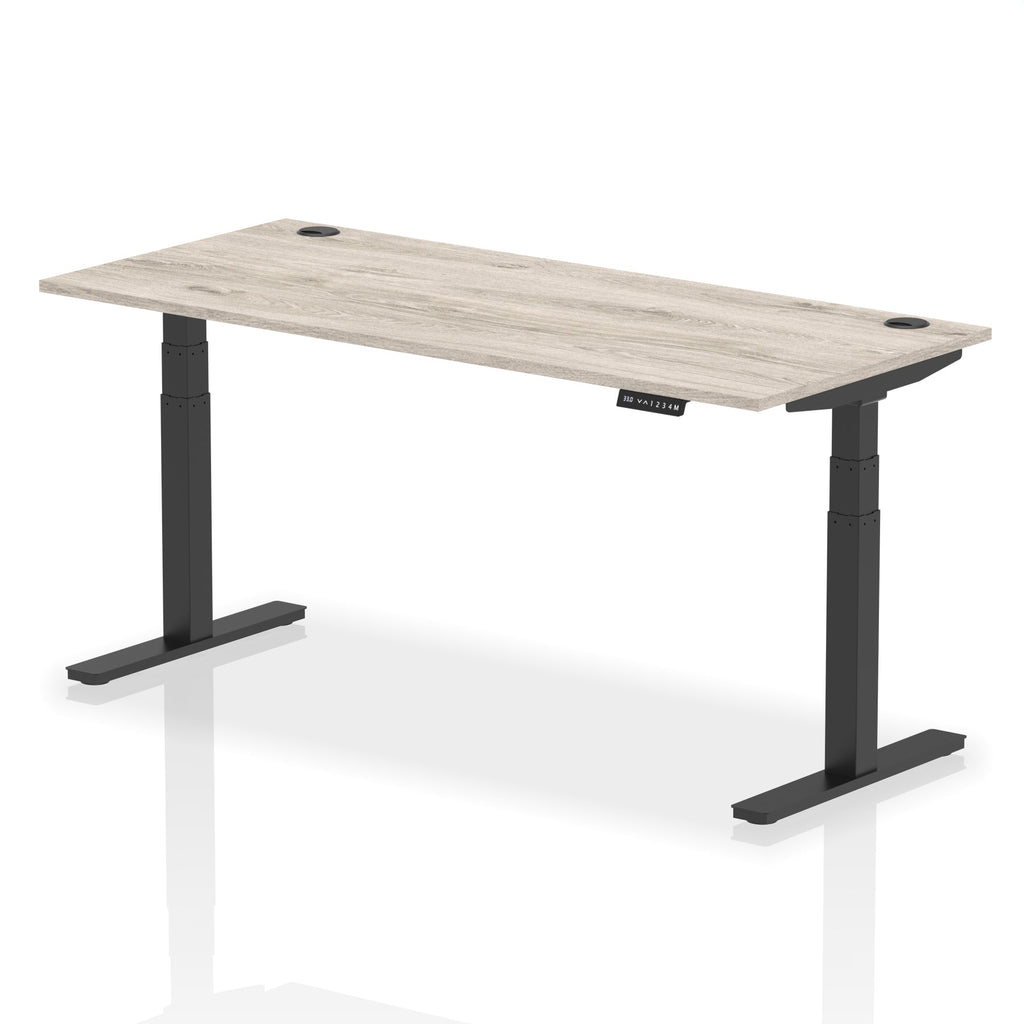 Adjustable height desk with wood-effect top and metal legs on a white background