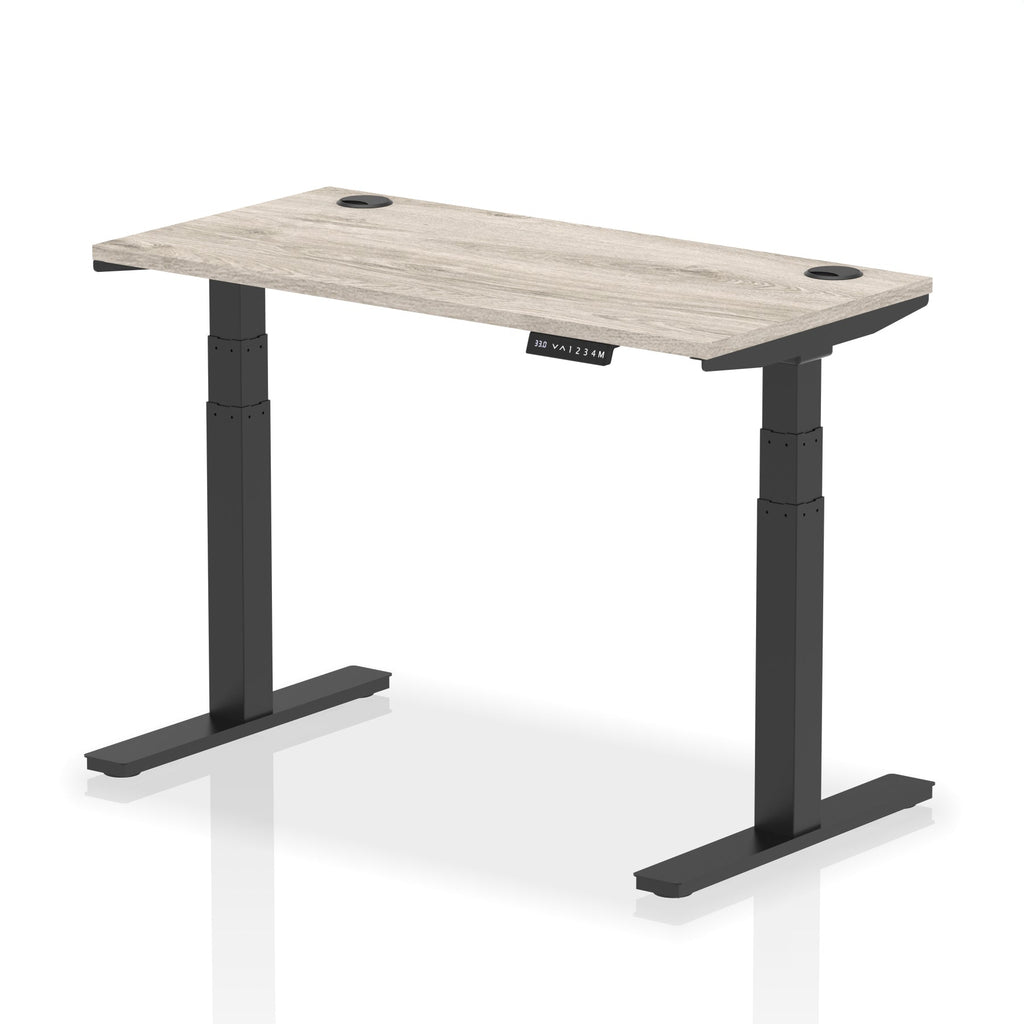 Adjustable height desk with wood-effect top and metal legs on a white background