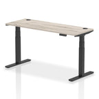 Adjustable height desk with wood-effect top and metal legs on a white background