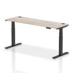 Adjustable height desk with wood-effect top and metal legs on a white background