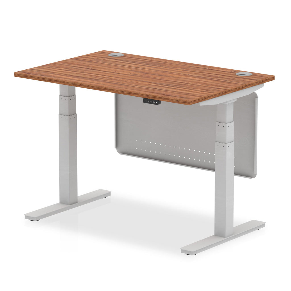 Adjustable height desk with wood-effect top and metal legs with modesty panel on a white background
