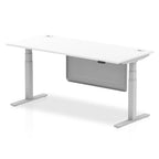 Adjustable height desk with white top and metal legs with modesty panel on a white background
