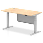 Adjustable height desk with wood-effect top and metal legs with modesty panel on a white background