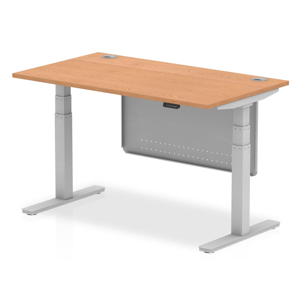 Adjustable height desk with wood-effect top and metal legs with modesty panel on a white background