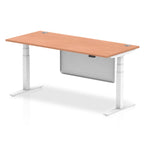 Adjustable height desk with wood-effect top and metal legs with modesty panel on a white background