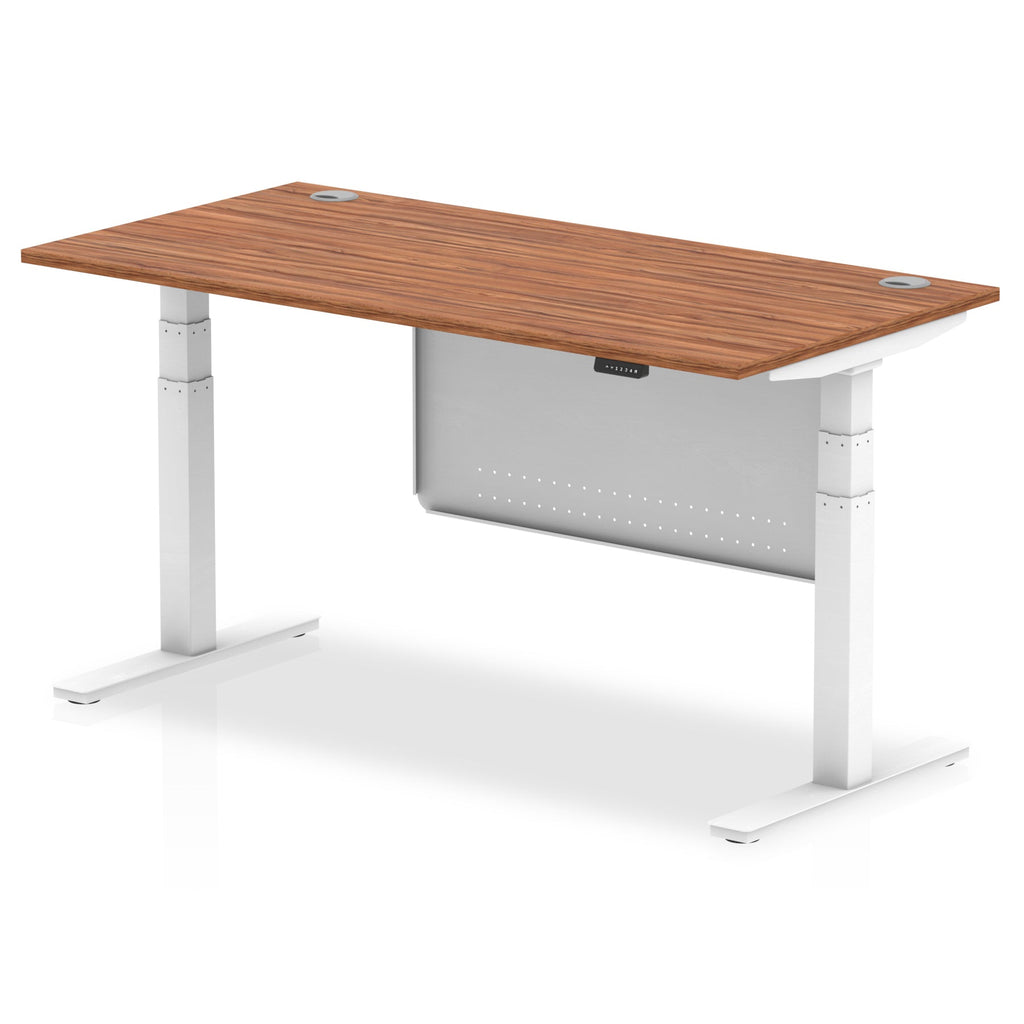 Adjustable height desk with wood-effect top and metal legs with modesty panel on a white background