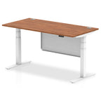 Adjustable height desk with wood-effect top and metal legs with modesty panel on a white background