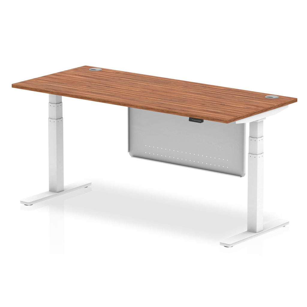 Adjustable height desk with wood-effect top and metal legs with modesty panel on a white background