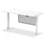 Adjustable height desk with white top and metal legs with modesty panel on a white background