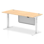 Adjustable height desk with wood-effect top and metal legs with modesty panel on a white background
