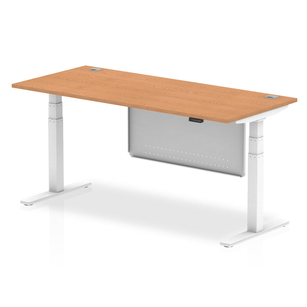 Adjustable height desk with wood-effect top and metal legs with modesty panel on a white background