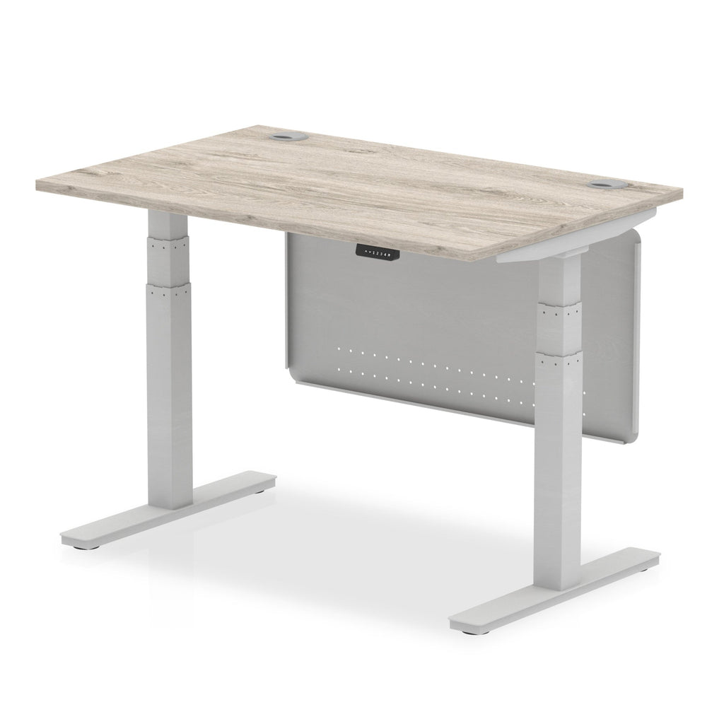 Adjustable height desk with wood-effect top and metal legs with modesty panel on a white background