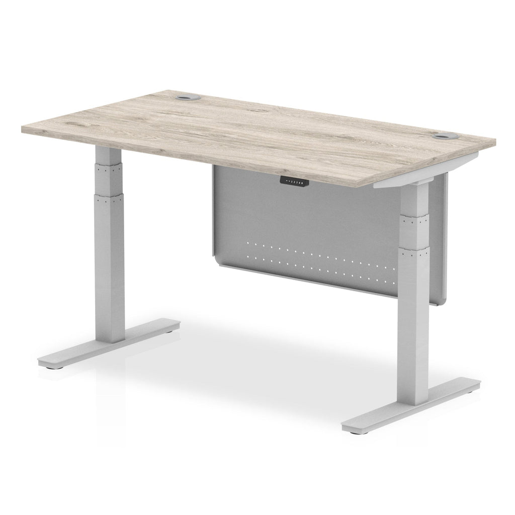 Adjustable height desk with wood-effect top and metal legs with modesty panel on a white background
