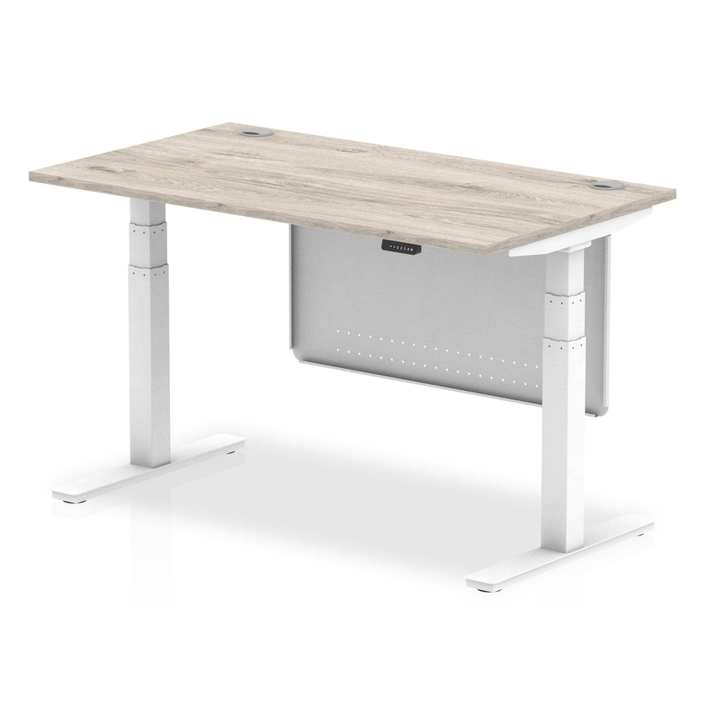 Adjustable height desk with wood-effect top and metal legs with modesty panel on a white background