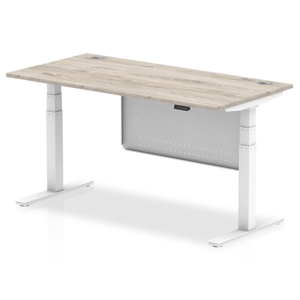 Adjustable height desk with wood-effect top and metal legs with modesty panel on a white background