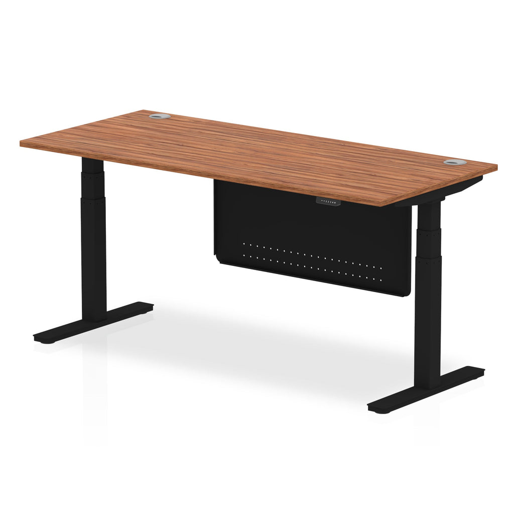 Adjustable height desk with wood-effect top and metal legs with modesty panel on a white background