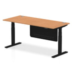 Adjustable height desk with wood-effect top and metal legs with modesty panel on a white background
