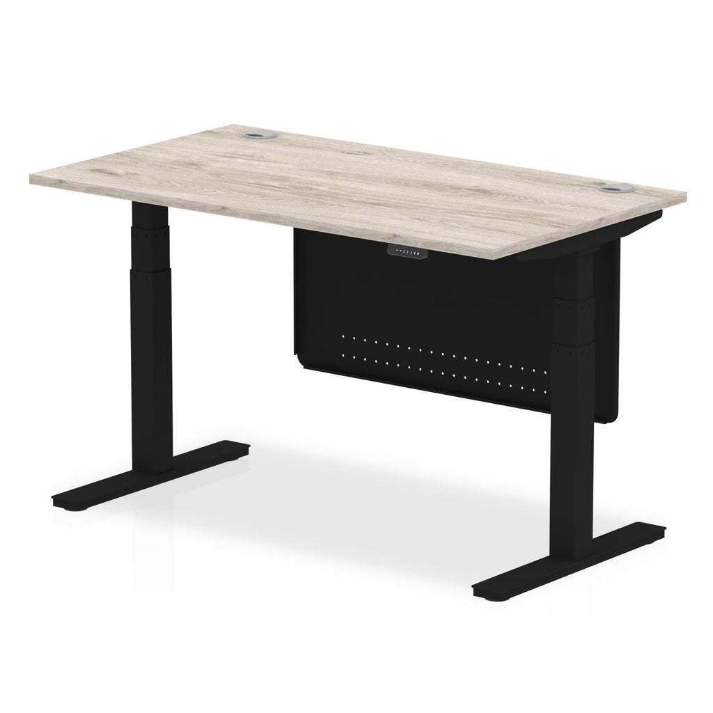 Adjustable height desk with wood-effect top and metal legs with modesty panel on a white background