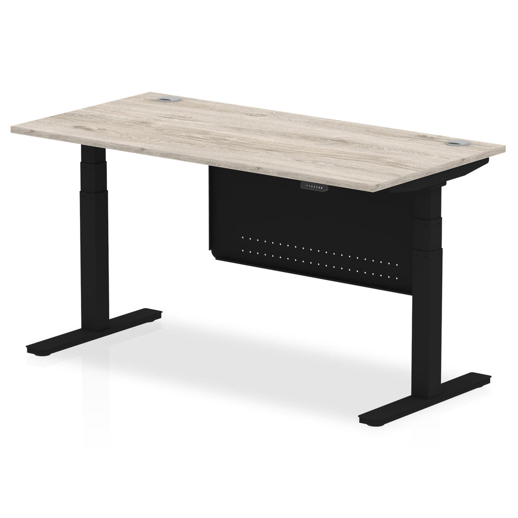 Adjustable height desk with wood-effect top and metal legs with modesty panel on a white background