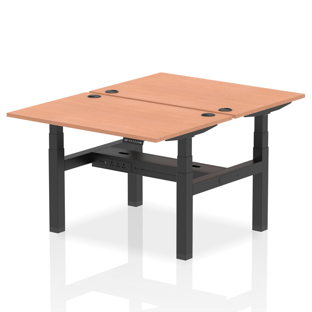 Back-to-back height adjustable desk with wood-effect top and black frame on a white background