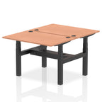 Back-to-back height adjustable desk with wood-effect top and black frame on a white background